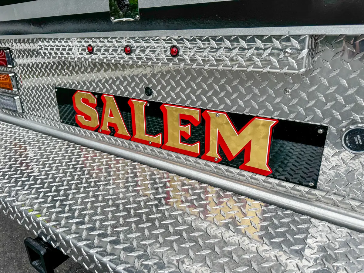 Upper side name panel close-up with roll-up compartment edge.